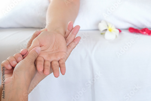 Hand spa massage over clean white bed background - people relax with hand massage service