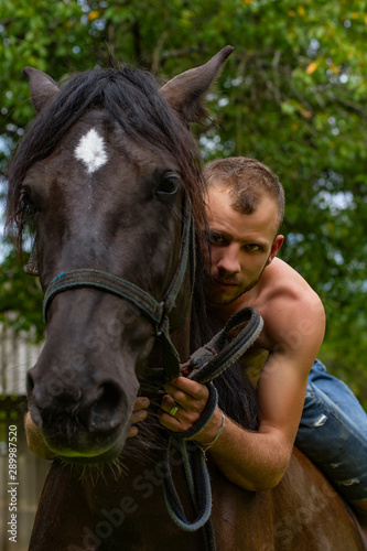 man with a naked torso riding horse
