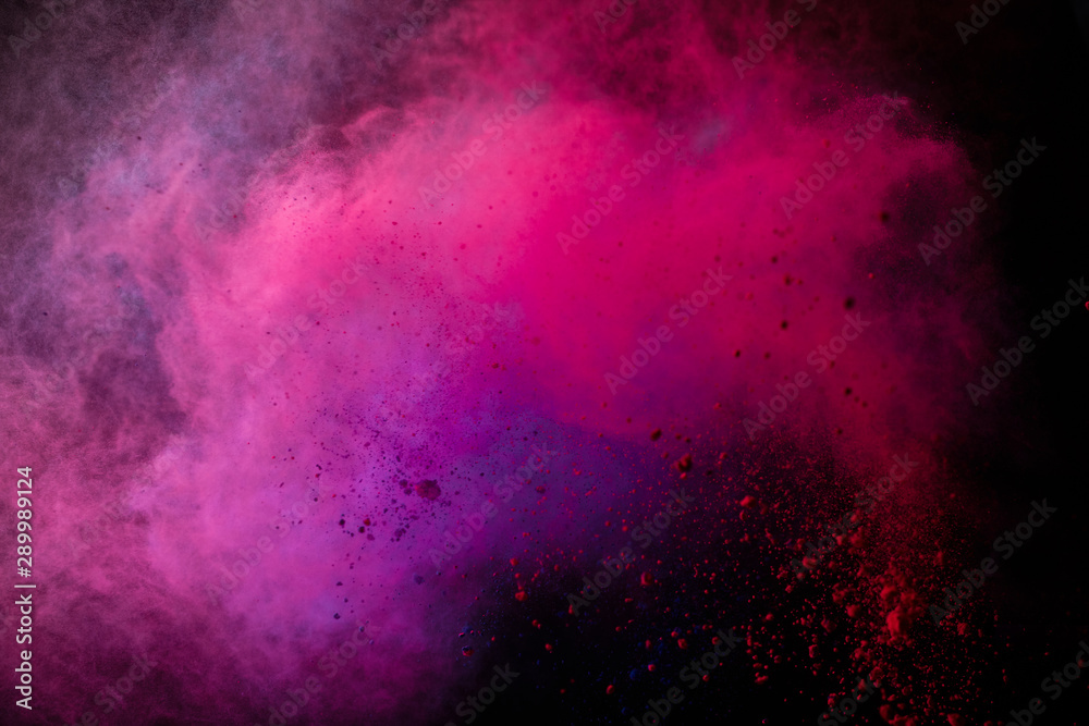 Freeze motion of colored dust explosion isolated on black background.
