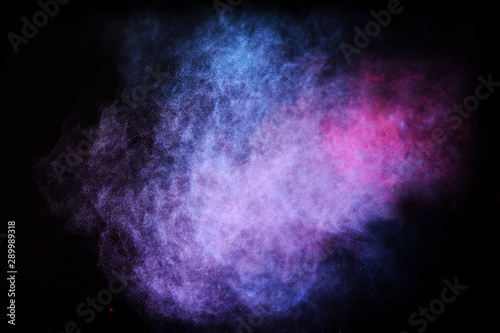 Freeze motion of colored dust explosion isolated on black background.