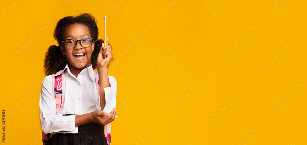 African American Girl Raising Hand Holding Pencil, Yellow Background