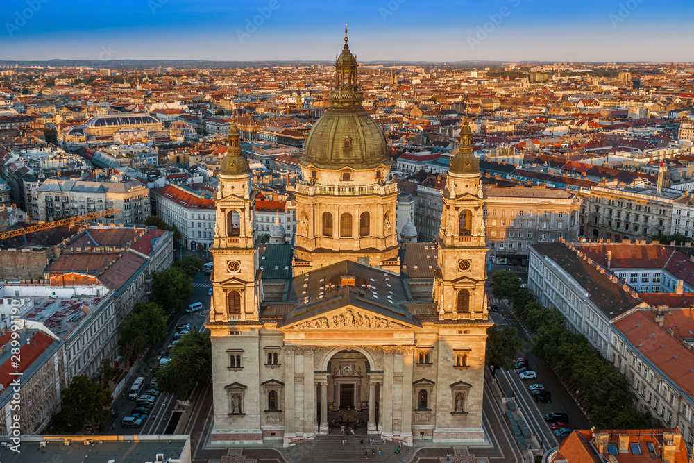 Budapest, Hungary - Aerial drone view of the beautiful St. Stephen's Basilica at sunset with warm summer afternoon lights and clear blue sky
