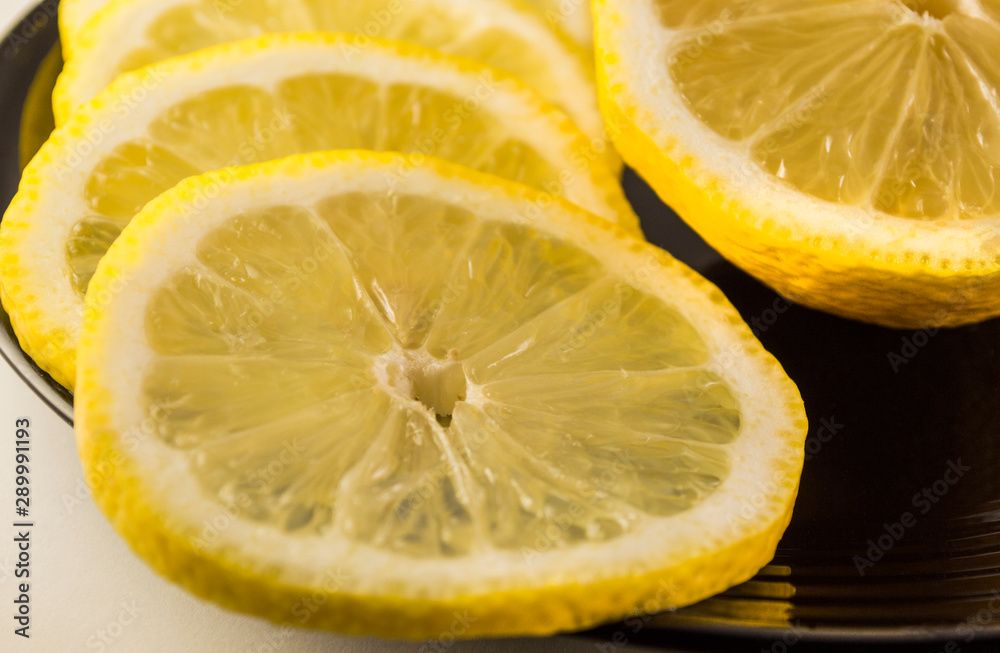 lemon slices on a black plate, closseup lemon slices on a black plate, closseup