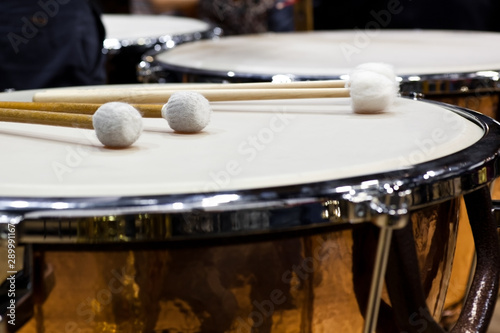 Drumsticks lying on timpani closeup