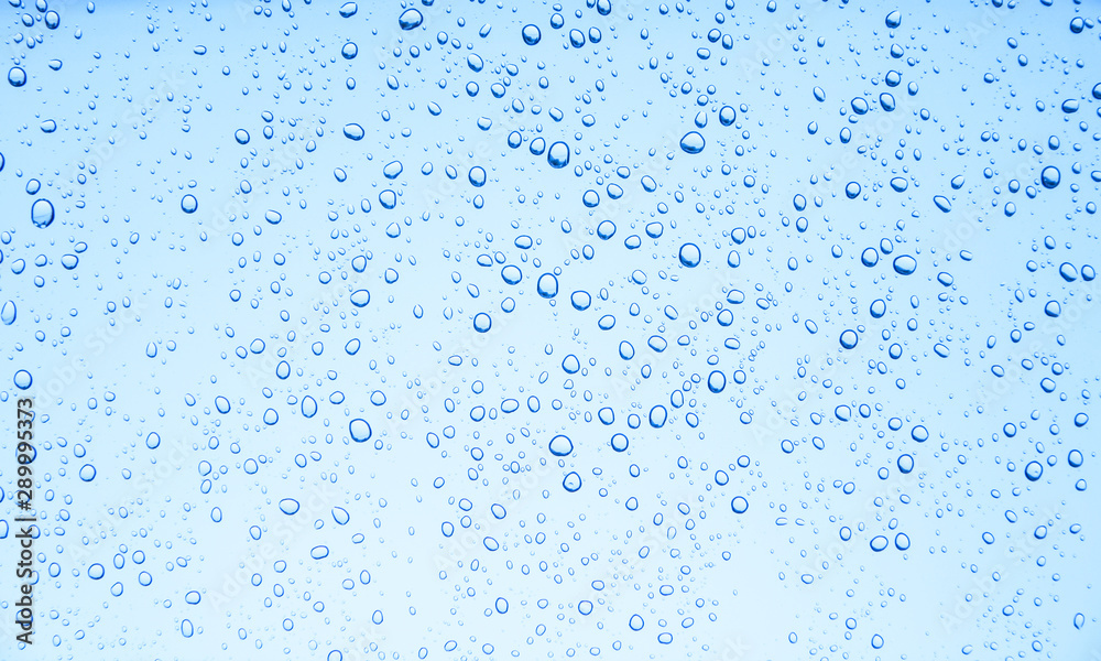 Blue background of water drops on glass or rain drop Blue background of water drops on glass or rain drop