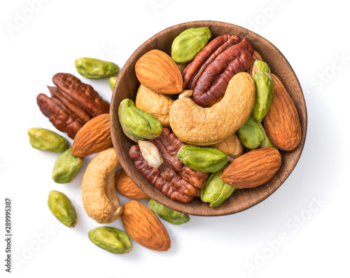 unsalted mixed nuts in the wooden bowl, isolated on white background, top view