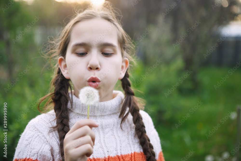 Teen girl and dandelions.