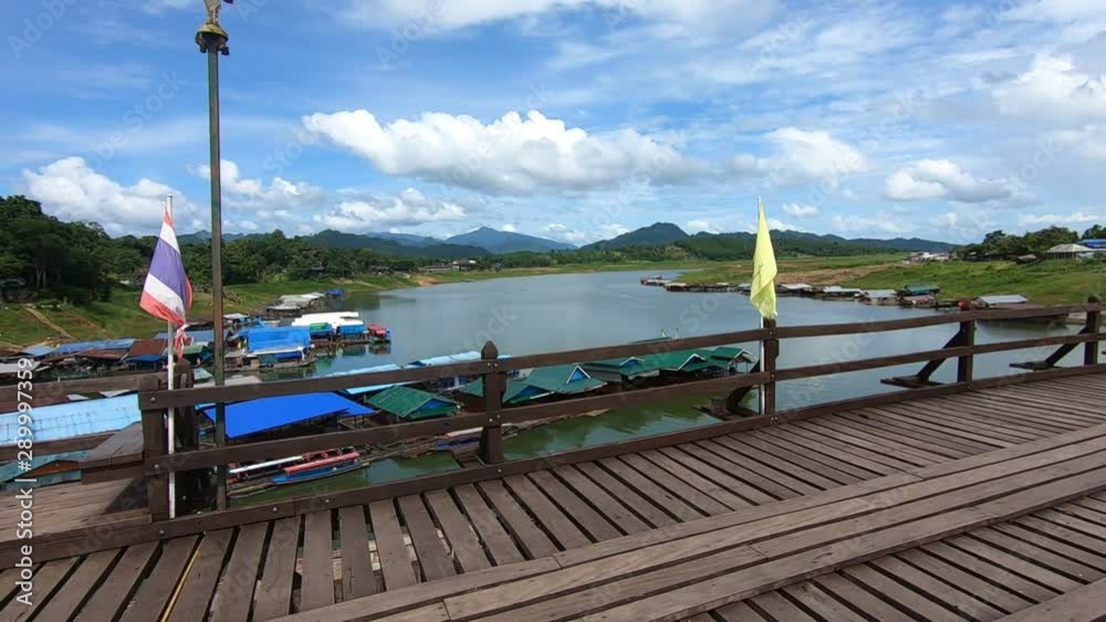 Mon Bridge in Sangkklaburi, Kanchanaburi, Thailand. A high wooden bridge spanning a flooded valley Mon Bridge in Sangkklaburi, Kanchanaburi, Thailand. A high wooden bridge spanning a flooded valley