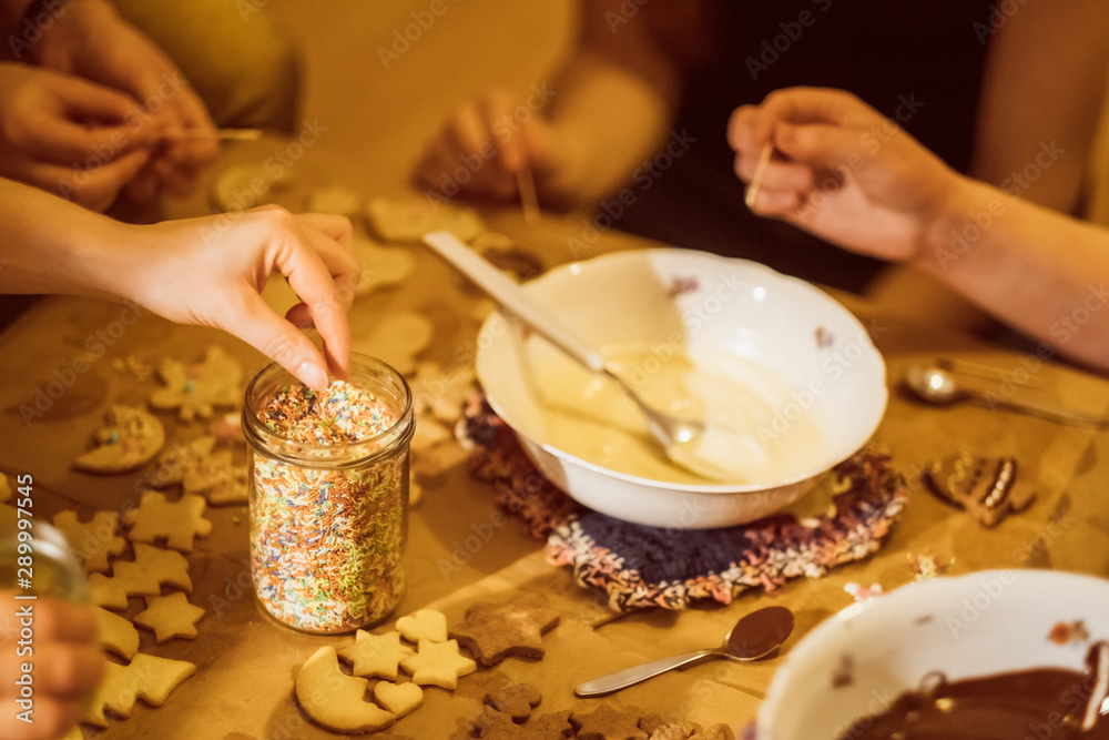 Group of young people baking cookies for christmas