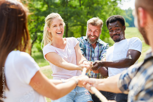 Group in tug-of-war with rope as a team