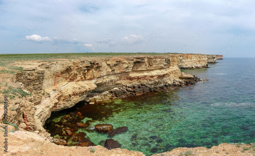 Panorama of sea coast with steep textured limestone rocks