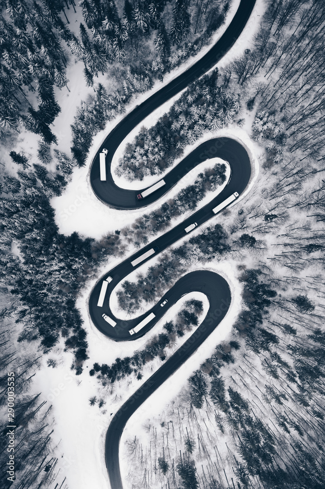 Trucks on a winding road in winter time