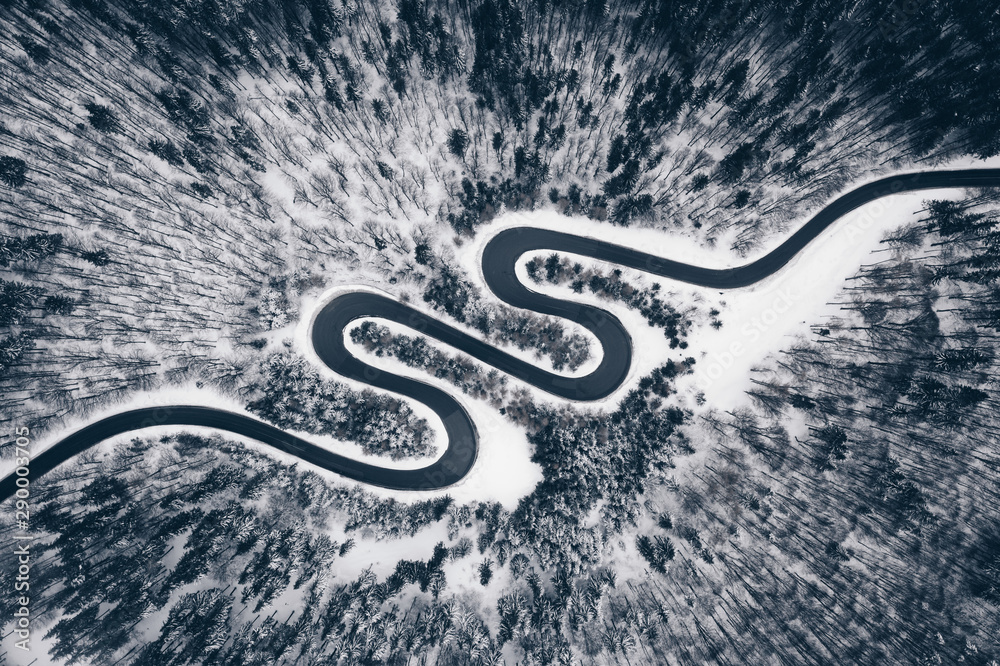 Aerial view of a winter road in the forest