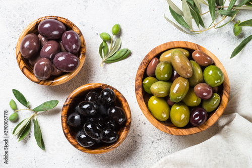 Black and green olives on white background.