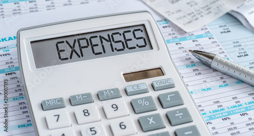 A calculator with the word Expenses on the display