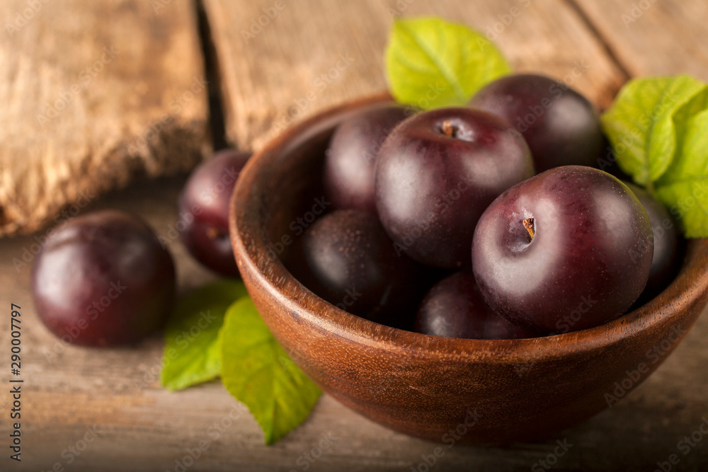 Freshly harvested healthy organic plums in a bowl Freshly harvested healthy organic plums in a bowl