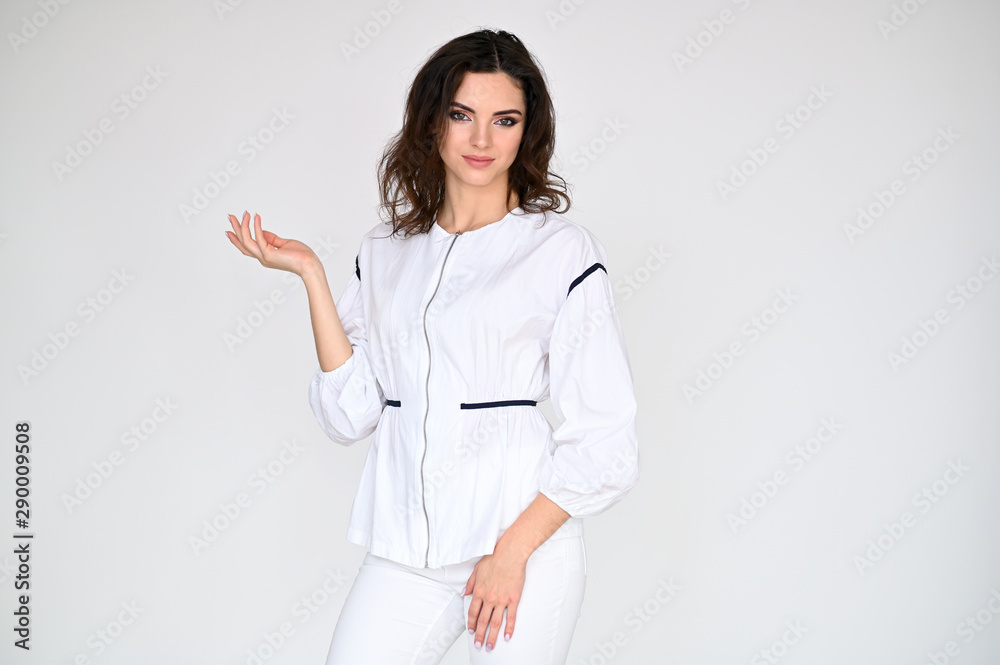 Concept photo portrait of a cute pretty beautiful brunette girl with great makeup in white clothes on a white background. In different poses with emotions. Concept photo portrait of a cute pretty beautiful brunette girl with great makeup in white clothes on a white background. In different poses with emotions.