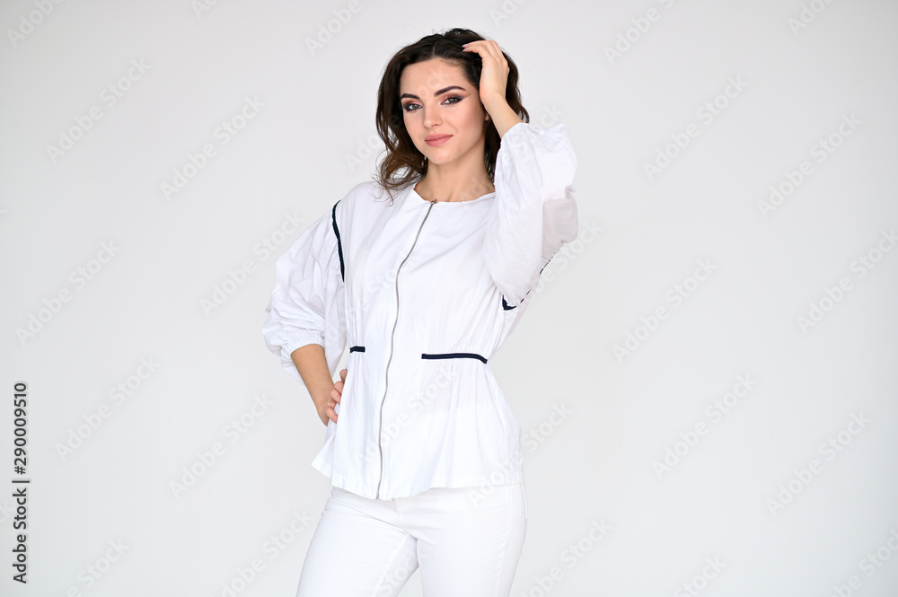 Concept photo portrait of a cute pretty beautiful brunette girl with great makeup in white clothes on a white background. In different poses with emotions. Concept photo portrait of a cute pretty beautiful brunette girl with great makeup in white clothes on a white background. In different poses with emotions.