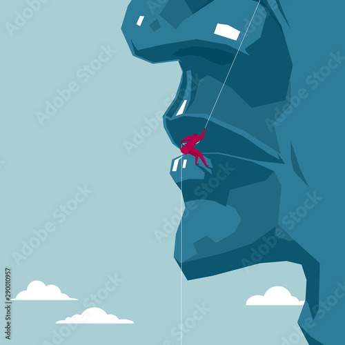 Businessman rock climbing on a huge face. The background is blue.
