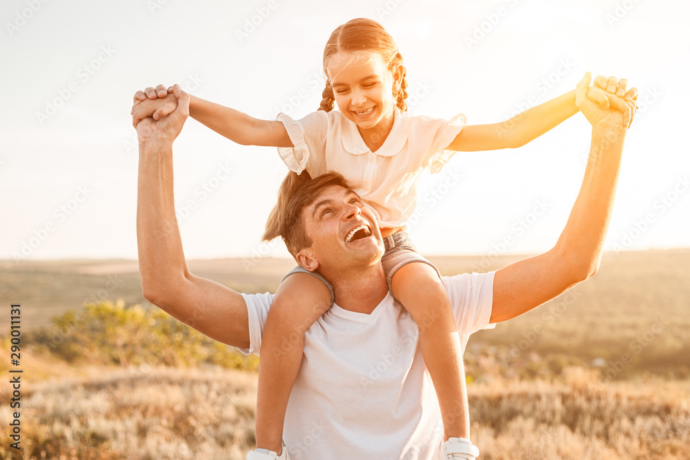 Excited father carrying daughter on neck Excited father carrying daughter on neck