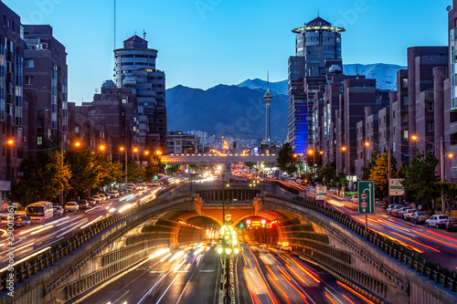 06/05/2019 Tehran,Iran,Famous night view of Tehran,Flow of traffic round Tohid Tunnel with Milad Tower and Alborz Mountains in Background, Tohid Tunnel one of longest urban tunnel in Middle East