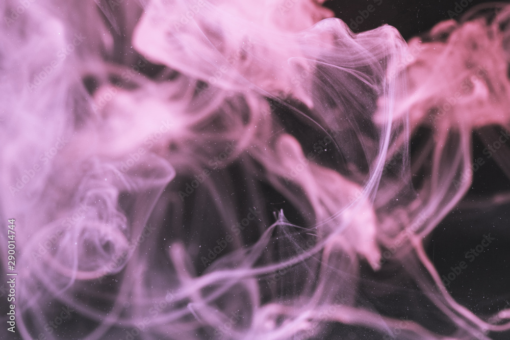 Fototapeta premium Defocused violet smoke on black screen