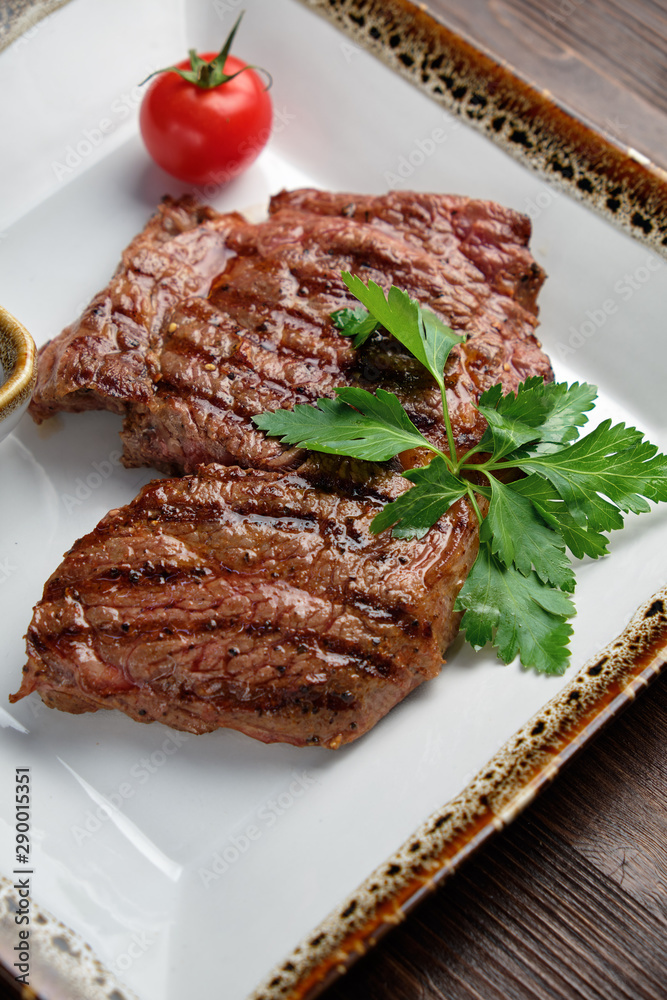 Steak on the bone with red sauce. restaurant menu Steak on the bone with red sauce. restaurant menu
