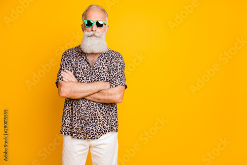 Portrait of concentrated modern retired old bearded businessman on rest resort look funny funky wear leopard print shirts pants trendy outfit isolated over yellow background