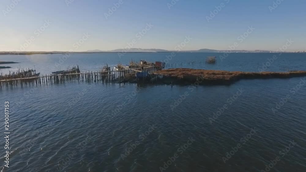 Flying over a traditional fishermen's quay with absolute photogenic views over the Sado Estuary Natural Reserve, in Portugal Flying over a traditional fishermen's quay with absolute photogenic views over the Sado Estuary Natural Reserve, in Portugal