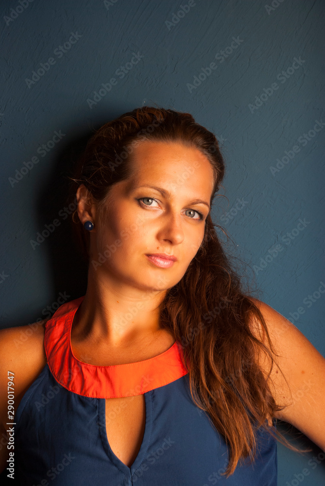 Portrait of beautiful woman with long hair in blue dress. Portrait of beautiful woman with long hair in blue dress.