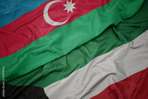 waving colorful flag of kuwait and national flag of azerbaijan.