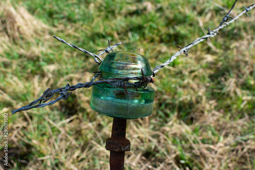 Old vintage rusty electric glass insulator with left and right wire