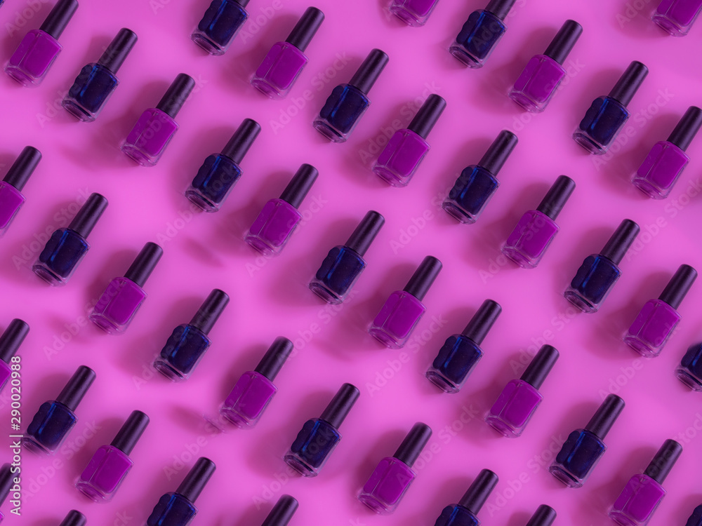 Nails polish bottle pattern on pink background Nails polish bottle pattern on pink background