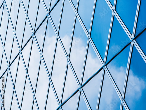 Architecture details Modern Building Glass facade steel pattern Reflection blue sky