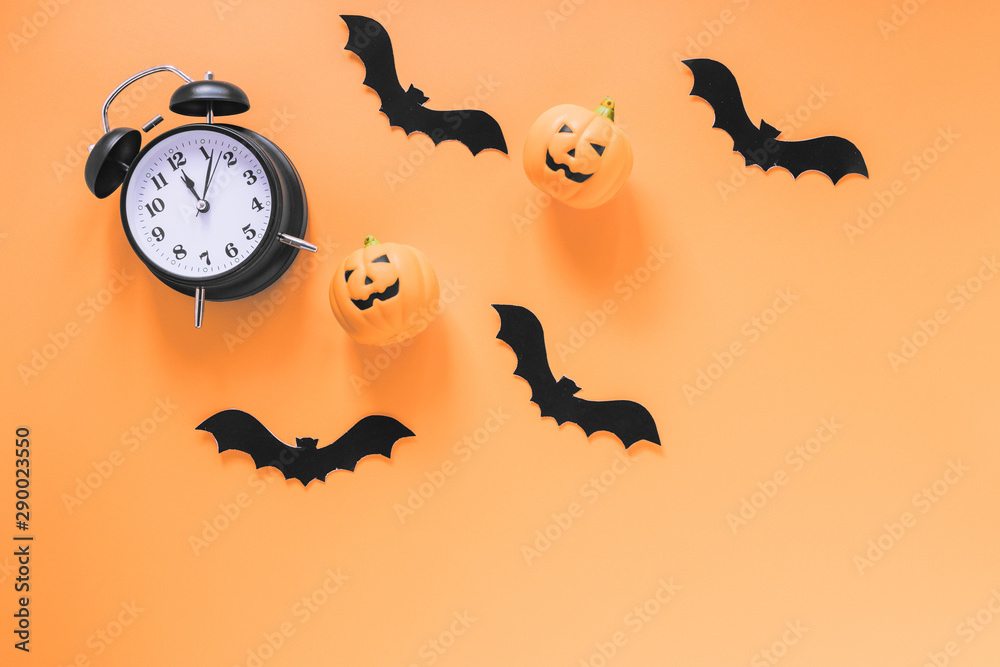 Alarm clock with paper bats and pumpkins