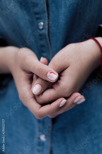 Two woman hands in pray pose showing trendy light manicure.