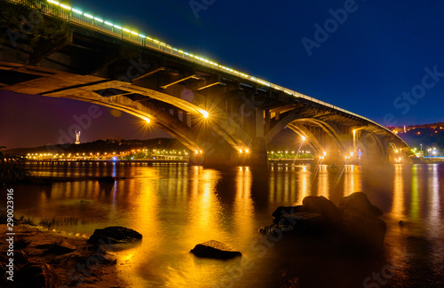 Metro Bridge and Dnieper River at night in Kyiv.