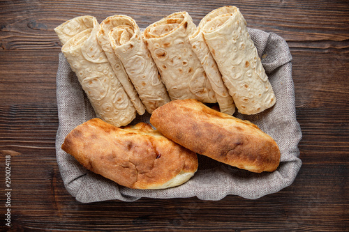 Pita bread of different types in a bread basket . restaurant menu