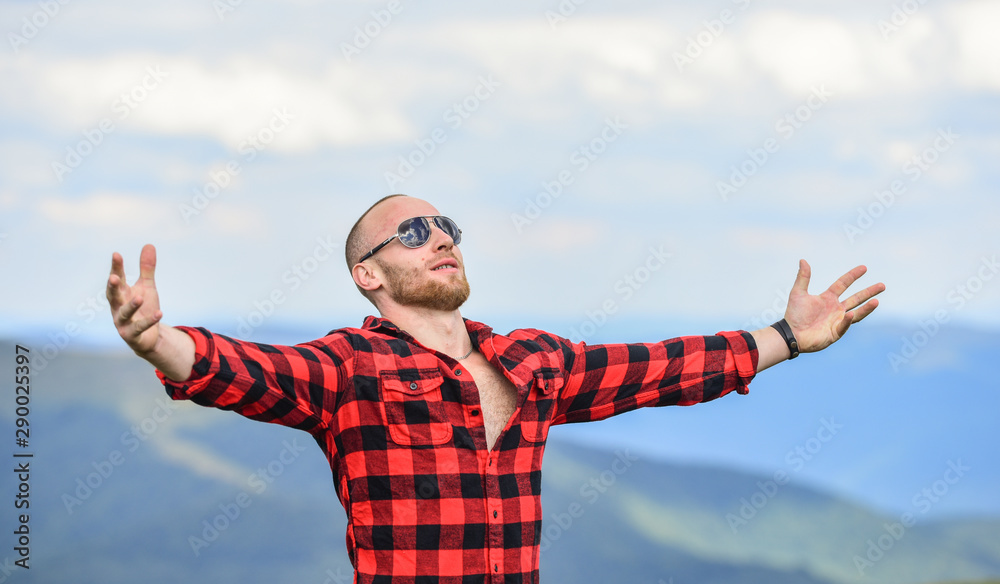 Fototapeta premium Hug whole world. Masculinity and male energy. Achieve freedom. Free and wild. Value of freedom. Self sufficient. Man stand on top of mountain. Hiking concept. Active leisure. Guy enjoy freedom