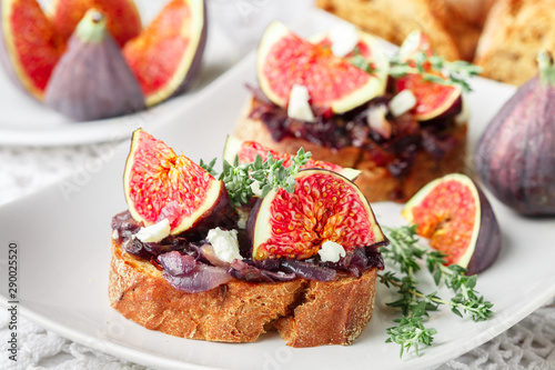 Grain baguette sandwiches with figs, feta cheese, red onion marmalade and thyme . Delicious snack for gourmands. Selective focus
