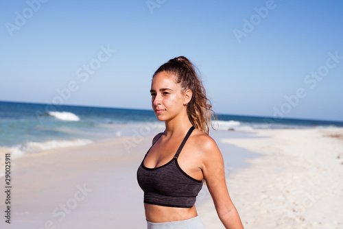 Young woman with her arms stretched behind her