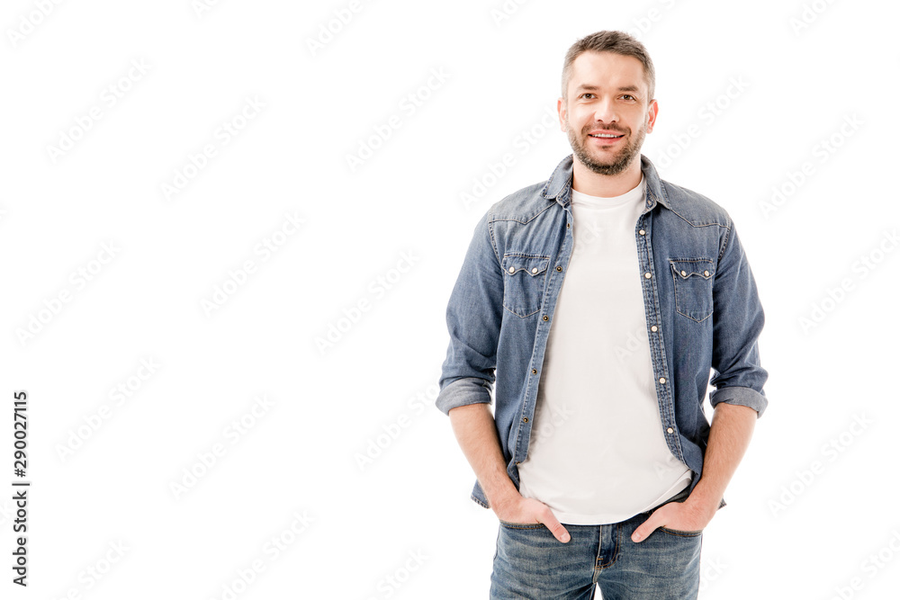 front view of smiling bearded man in denim shirt standing with hands in pockets isolated on white front view of smiling bearded man in denim shirt standing with hands in pockets isolated on white