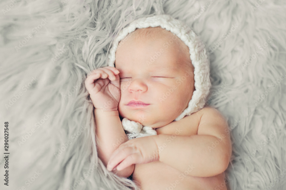 Portrait of pretty newborn. Cute baby sleeping and smiling Portrait of pretty newborn. Cute baby sleeping and smiling