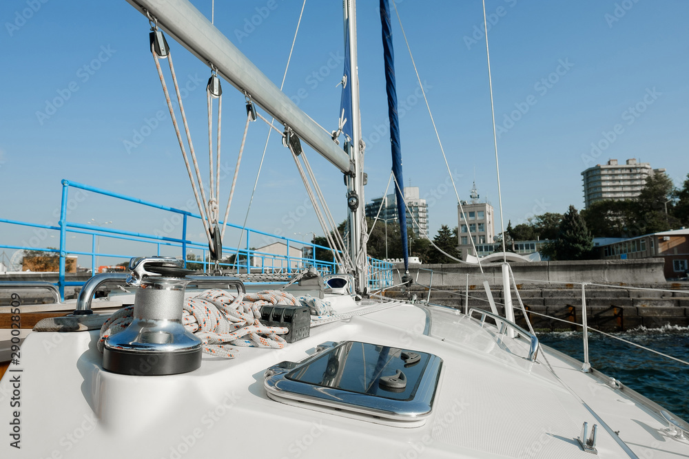 Yacht on ocean. Sailing ship with white sails in the open sea. View from the yacht's deck to mast and sail. Sport, vacation, travel, summer, activity concept Yacht on ocean. Sailing ship with white sails in the open sea. View from the yacht's deck to mast and sail. Sport, vacation, travel, summer, activity concept