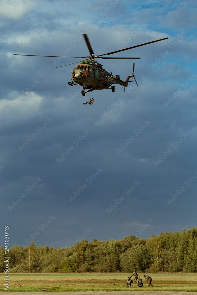 Fototapeta premium Landing of special forces on a rope from a Mi-8 helicopter