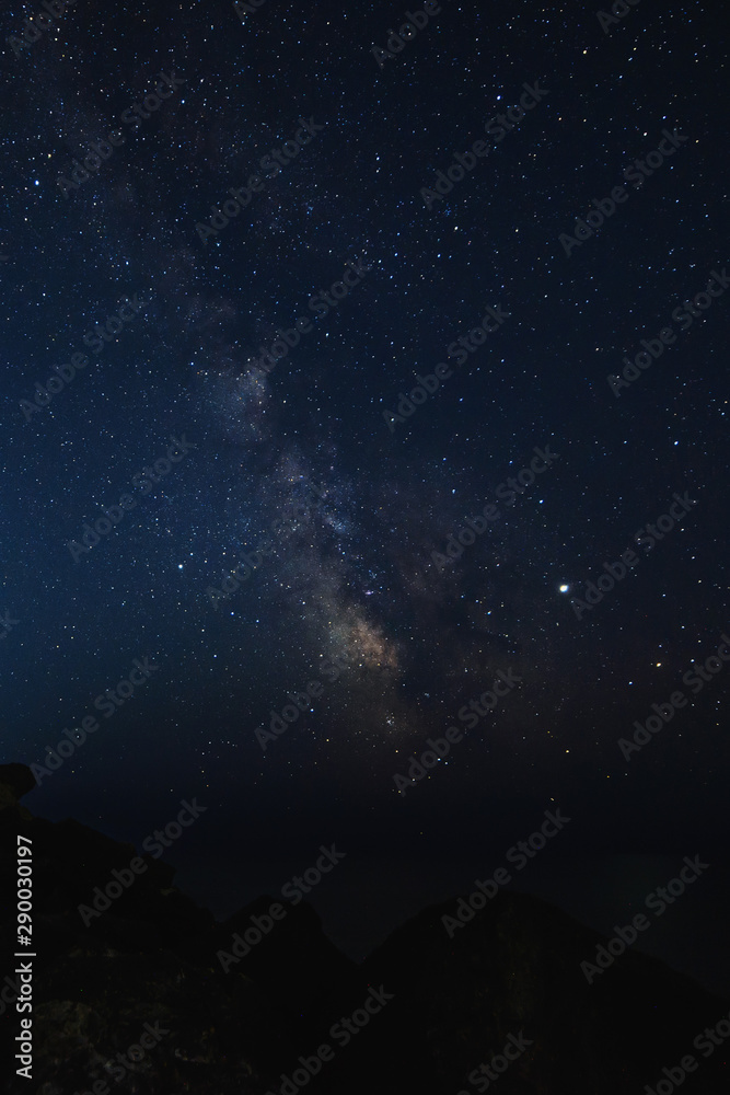 Starry sky at night on the sea coast