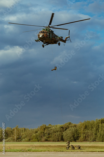 Landing of special forces on a rope from a Mi-8 helicopter