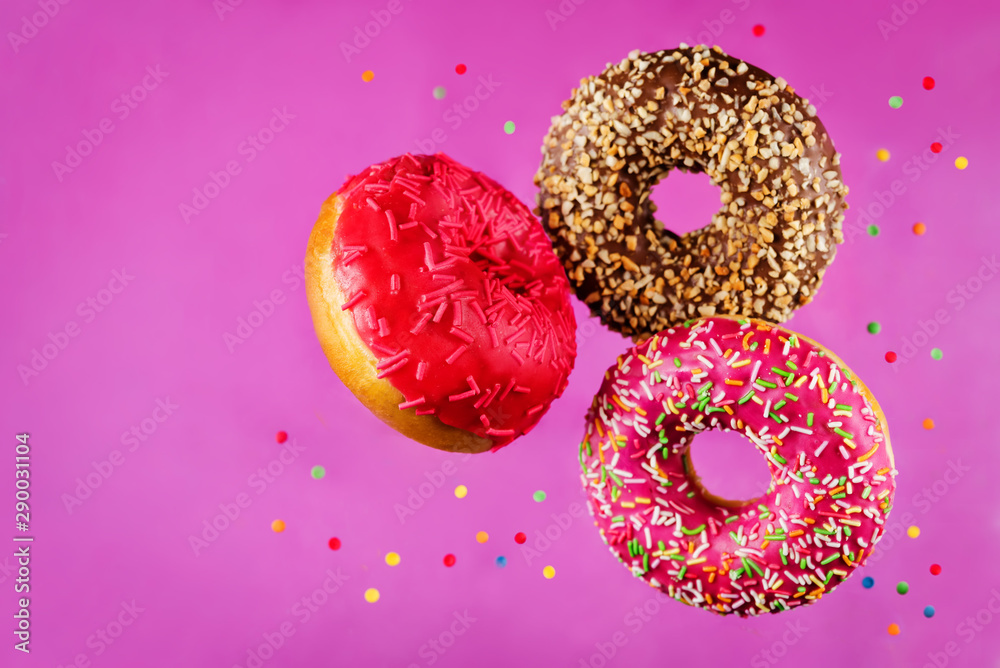Flying multicolored Donuts with sprinkles Flying multicolored Donuts with sprinkles