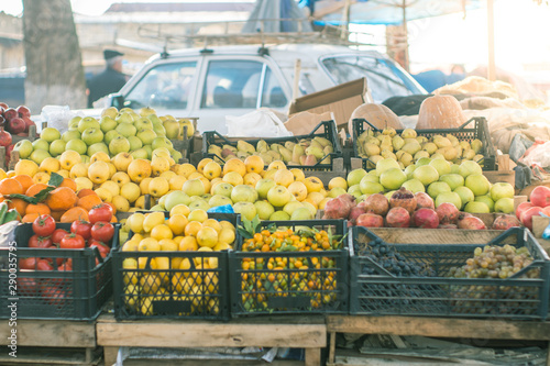 Fruit market at town. Stack of fruits, apples pomegranates, pears, grapes etc. for sale. photo