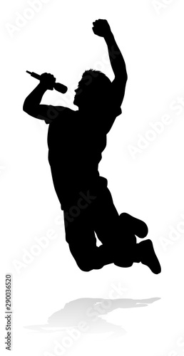 A singer pop, country music, rock star or hiphop rapper artist vocalist singing in silhouette